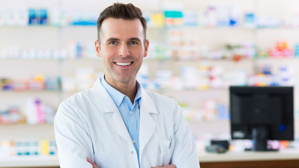Pharmacist offering NHS consultation at CarePoint Pharmacy in Airdrie