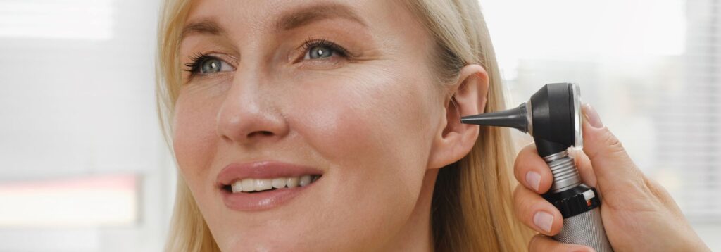 Pharmacist conducting professional ear wax removal at CarePoint Pharmacy in Airdrie
